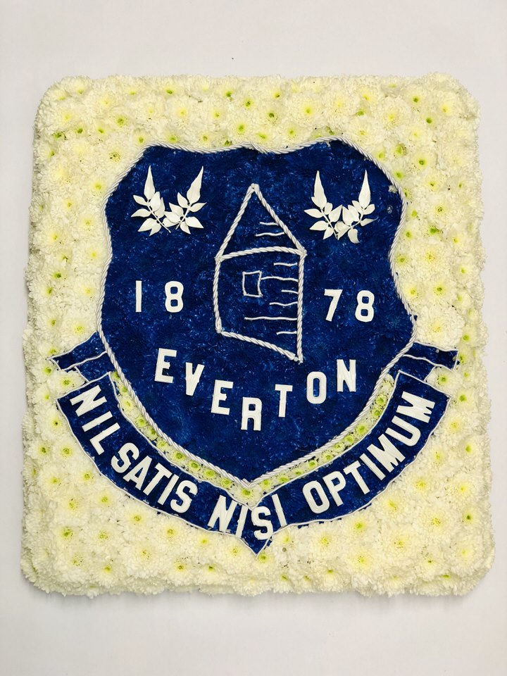 <h2>Football Badge Tribute | Funeral Flowers</h2>
<ul>
<li>Approximate Size 2ft x 1.5 ft</li>
<li>Hand created Everton Football Club flag (can be done for other Clubs)</li>
<li>To give you the best we may occasionally need to make substitutes</li>
<li>Funeral Flowers will be delivered at least 2 hours before the funeral</li>
<li>For delivery area coverage see below</li>
</ul>
<br>
<h2>Liverpool Flower Delivery</h2>
<p>We have a wide selection of Bespoke Funeral Tributes offered for Liverpool Flower Delivery. Bespoke Funeral Tributes can be provided for you in Liverpool, Merseyside and we can organize Funeral flower deliveries for you nationwide. Funeral Flowers can be delivered to the Funeral directors or a house address. They can not be delivered to the crematorium or the church.</p>
<br>
<h2>Flower Delivery Coverage</h2>
<p>Our shop delivers funeral flowers to the following Liverpool postcodes L1 L2 L3 L4 L5 L6 L7 L8 L11 L12 L13 L14 L15 L16 L17 L18 L19 L24 L25 L26 L27 L36 L70 If your order is for an area outside of these we can organise delivery for you through our network of florists. We will ask them to make as close as possible to the image but because of the difference in stock and sundry items it may not be exact.</p>
<br>
<h2>Liverpool Funeral Flowers | Bespoke Tributes</h2>
<p>This Everton Football Club Flag has been loving handcrafted by our expert florists using a mass of spray chrysanthemums to make the Everton Club crest. It can be made for any football team in any colour. For example, can be made for Liverpool Football Club in Red.  An ideal funeral tribute for a football fan or football player.</p>
<br>
<p>Bespoke Funeral Tributes are a way to create a tribute that is truly unique and specially designed for a loved one.</p>
<br>
<p>These are sometimes selected by family members as the main tribute or more often a group of friends or workplace colleagues as a symbol of things they associate with the deceased.</p>
<br>
<p>The flowers are arranged in floral foam, which means the flowers have a water source so they look their very best for the day.</p>
<br>
<h2>Best Florist in Liverpool</h2>
<p>Trust Award-winning Liverpool Florist, Booker Flowers and Gifts, to deliver funeral flowers fitting for the occasion delivered in Liverpool, Merseyside and beyond. Our funeral flowers are handcrafted by our team of professional fully qualified who not only lovingly hand make our designs but hand-deliver them, ensuring all our customers are delighted with their flowers. Booker Flowers and Gifts your local Liverpool Flower shop.</p>
<br>
<p><em>Debera G - 5 Star Review on yell.com - Funeral Florist Liverpool</em></p>
<br>
<p><em>Fleur and her team made the flowers for my Dad's funeral. I knew I wanted something quite specific but was quite unsure how to execute the idea. Fleur understood immediately what I was hoping to achieve and developed the ideas into amazingly beautiful flowers that were just perfect. I honestly can't recommend her highly enough - she created something outstanding and unique for my Dad. Thanks Fleur.</em></p>